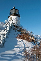 Lighthouse On Snow Covered Cliff